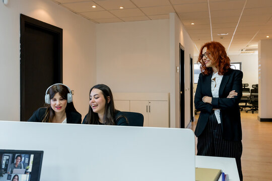 MBA students collaborate at computer with business mentor