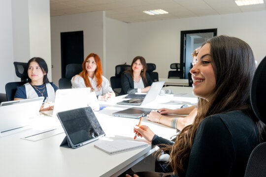 MBA students attend business class in modern classroom