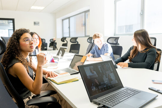 MBA students collaborate in a bright university classroom