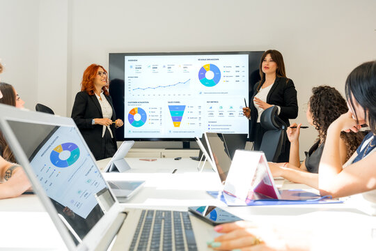 MBA students analyze business data during classroom presentation