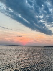 Fototapeta premium Dramatic fan shaped cloud formation over calm Black Sea at sunset
