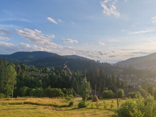 Obraz premium Scenic view of green Carpathian mountains hills covered with forest under cloudy sky