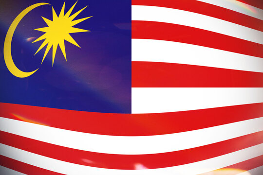 The Malaysian National Flag, Jalur Gemilang, Proudly Waving, Featuring Its Iconic Blue Canton with a Yellow Crescent Moon and 14 point Star, and Vibrant Red and White Stripes