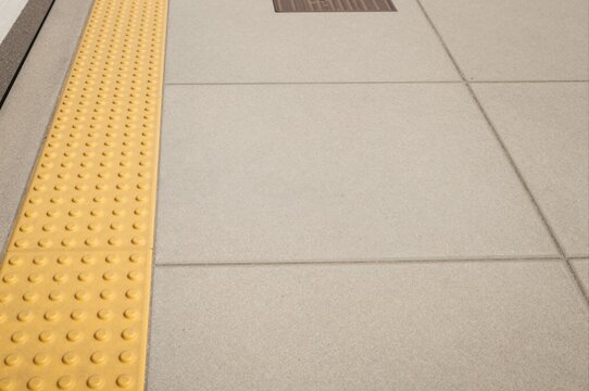 tactile paving for visually impaired guiding path at urban sidewalk intersection