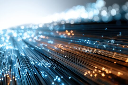 Abstract glowing fiber optic cables with blue and orange light trails creating dynamic high-speed data transmission concept in technology background