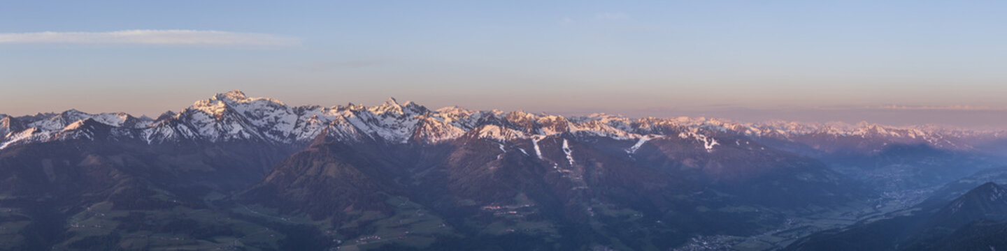 View of the snow-capped peaks of the Dachstein glacier at sunset, with alpine valleys and mountain ridges in Liezen District, Styria, Austria.