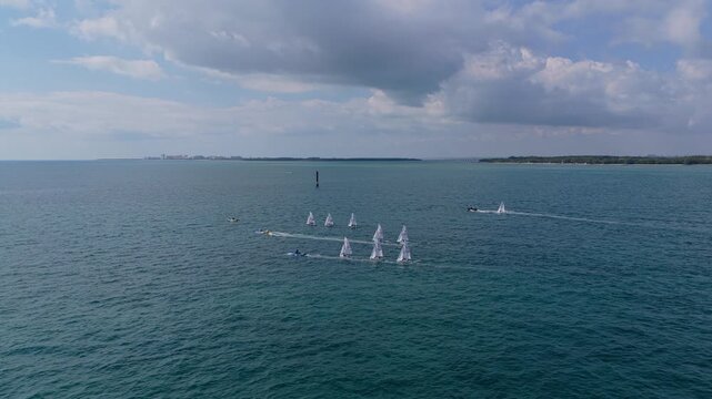 Miami sailing race. Sail training ship. Sailing boat at blue sky seascape. Ship sailing the sea. Sail boat at port of Miami. Travel by sea. Seascape horizon at sunset. Sea vacation. Sailboat vessel