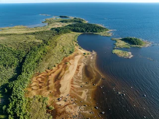 Aerial view of a scenic rocky cape on Lake Ladoga with low water level and sand textures on the dried beach, Karelia, Russia © es0lex