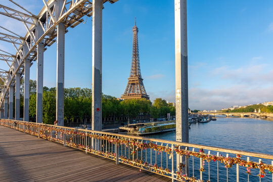 Eiffel tower and tourist locks on Debilly bridge over Seine river, Paris, France
