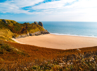 Tor Bay Gower- Secluded sandy cove framed by rocky headland and autumn-toned clifftop grass, Tor Bay, Gower Peninsula, Wales. © helen