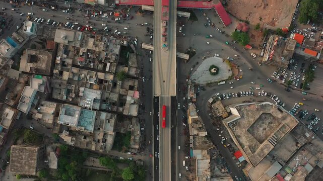 Elevated metro station with red bus in dense urban area around city rawalpindi
