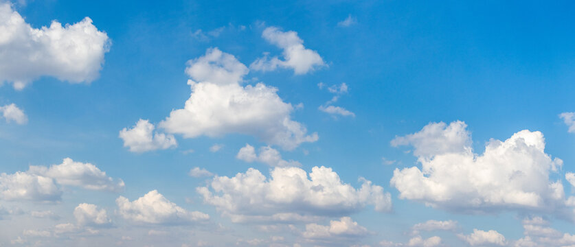 Panoramic blue sky with fluffy white clouds on sunny day