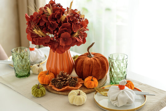 Autumn Thanksgiving Table Setting With Pumpkins Flowers And Glasses For Festive Dinner