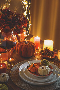 Elegant Autumn Harvest Thanksgiving Dinner Table Setting with Pumpkins Candles and Wine