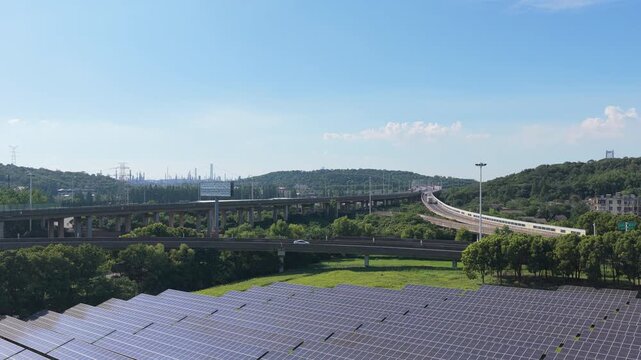 Aerial view of solar panels beside intersecting elevated roads