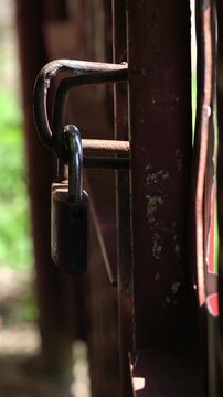The old metal gate is closed and the chain and lock are closed. Closed territory