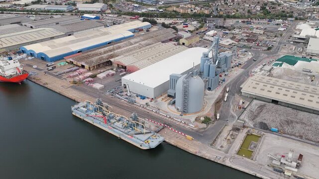 Aerial View of Industrial Port Facility With Cargo Ships and Silos During Daylight Hours