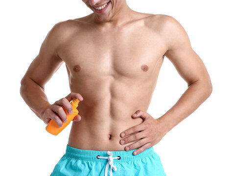 Happy man applying sunscreen on his tan skin against white background, closeup