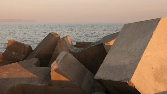 Unique cubist concrete blocks, New Harbor, Hermanus, South Africa at sunset. 