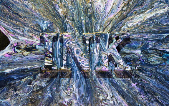 Marbled paint letters INK emerging from swirling metallic blue and purple pour
