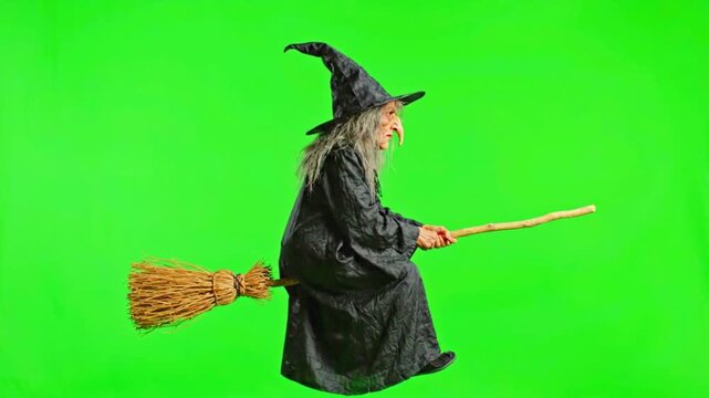 Halloween witch flying on a broomstick. Cartoon female sorceress with hat and cloak soaring on green screen