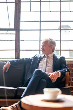 Businessman relaxing in modern office.