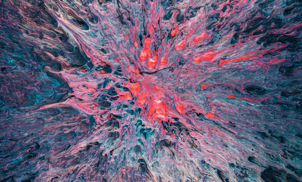 Explosion of multicolored poured paint with flowing organic textures and radial motion