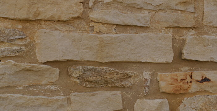 Rustic Abstract Stone Wall Texture Wallpaper Background - Earthy Beige Brown Tones for Natural Design Elements Construction Visuals