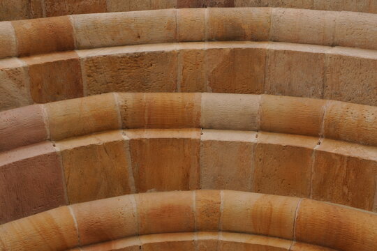 Warm Earthy Abstract Stone Archway Texture Background - Rough Sandstone Pattern Wallpaper for Architectural Decor Design Projects