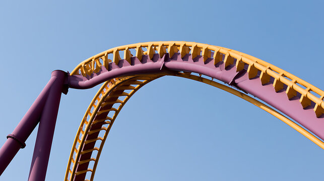 Vibrant Yellow and Purple Roller Coaster Track Against a Clear Blue Sky, Capturing the Thrill and Excitement of an Amusement Park Ride