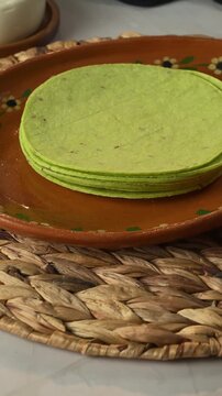 Organic green nopal corn tortillas served on a clay plate