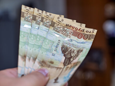 Russian Ruble Banknotes Held in Hand for Transaction