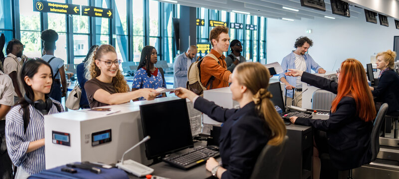 Travelers checking in at an airport during a busy afternoon