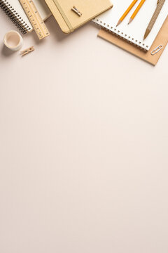 Back to school vertical desk with notebook, pencils, ruler and neutral stationery for study and planning