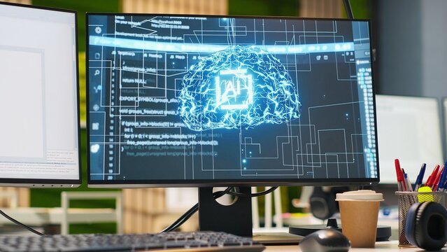 Office computer supports the design and implementation of machine learning algorithms, code reviews and bug fixing inside an empty technology startup workspace for software development.