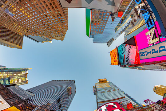 neon advertising of News, brands and theaters at times square in late afternoon
