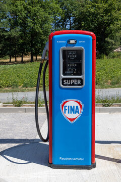 vintage Fina gas station with original gas pump in bright blue and red, featuring all original parts of a historic gas station on display in the Hessenpark open air museum.