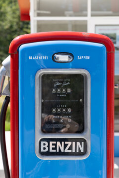 vintage Fina gas station with original gas pump in bright blue and red, featuring all original parts of a historic gas station on display in the Hessenpark open air museum.