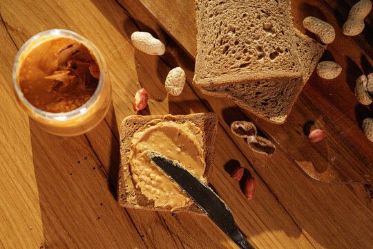 Peanut Butter Spread On Whole Grain Toast In Warm Morning Light