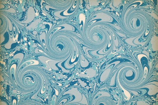 Blue and white marbled paper with swirling patterns. This antique endpaper texture features organic shapes and water like flow perfect for book arts and crafts.