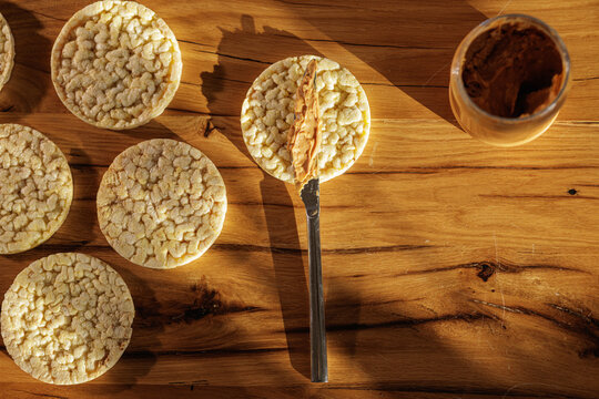 Spreading Peanut Butter On Rice Cakes For Simple Healthy Snack