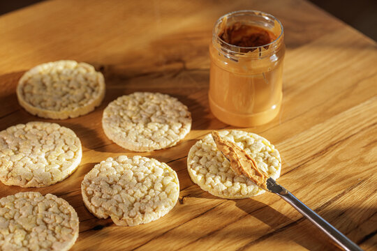 Spreading Peanut Butter On Rice Cakes For Healthy Snack