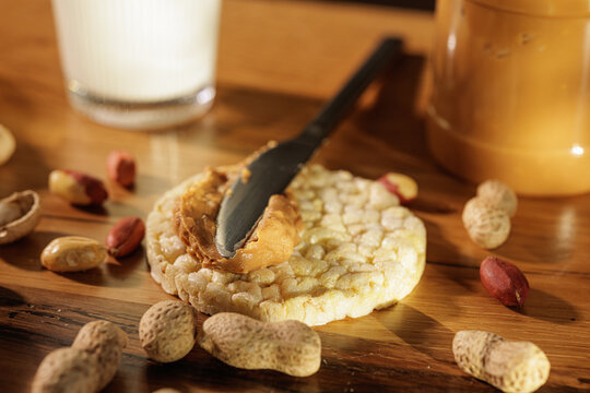 Spreading Peanut Butter On Crunchy Rice Cracker Snack