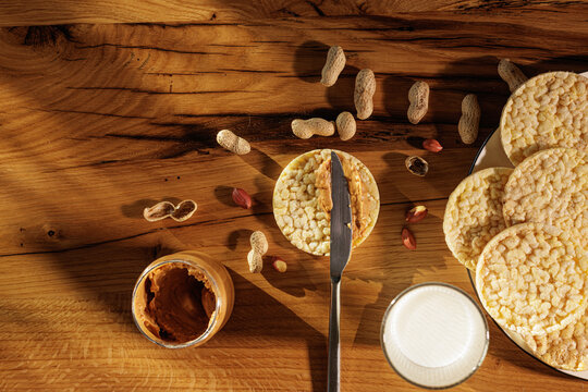 Spreading Peanut Butter On Rice Cakes For Simple Healthy Snack