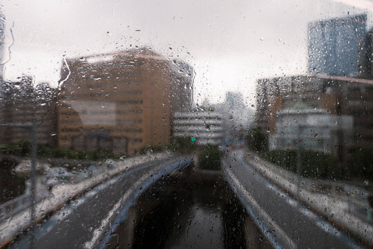 Rainy City Street Through Wet Window