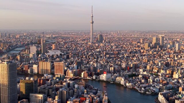 Aerial view of the Sumida River and Tokyo skyline at sunset in Sumida Ward, Central Tokyo, Japan.