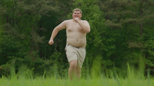 Overweight man begins exercise. Outdoor overweight workout effort. Jogging overweight body concept. Overweight runner seeks weight loss.