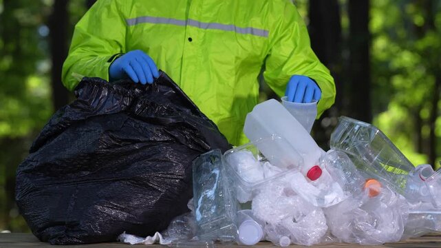 Plastic recycling supports ecology. Volunteer collecting waste in nature. Ecology cleanup reduces plastic pollution. Environmental hand sorting recycle garbage.