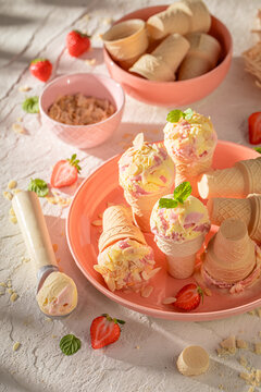 Tasty and sweet strawberry ice cream in a waffle cone.