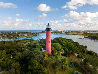 Lighthouse overlooking the coastal inlet, waterway, and residential communities in Florida under a blue sky with white clouds. December 29, 2022.  © JHorsey